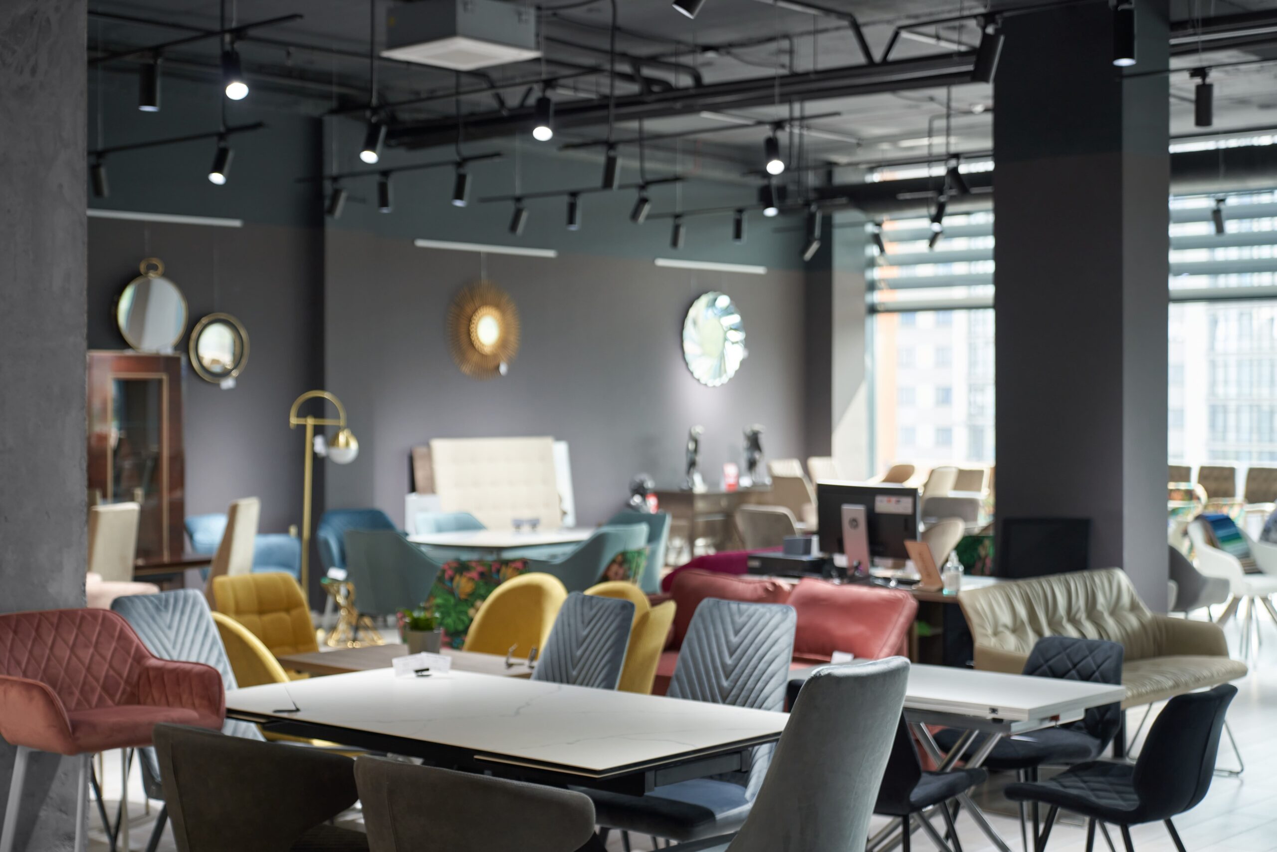 salon modern furniture shop with sofas chairs offering sale illuminated with light min scaled